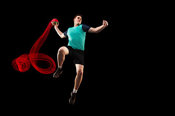 Image showing The one caucasian young man as handball player at studio on black background