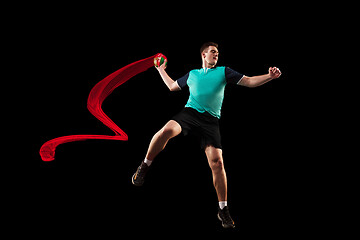 Image showing The one caucasian young man as handball player at studio on black background