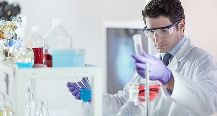 Image showing Researcher performing scientific experiment in chemical laboratory.