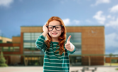 Image showing red haired student girl in glasses over school