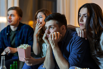 Image showing friends with beer and popcorn watching tv at home