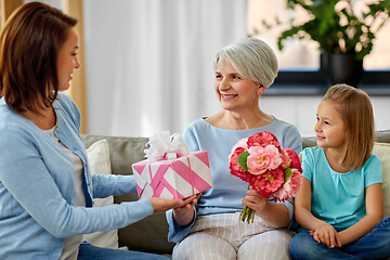 Image showing female family giving present to grandmother