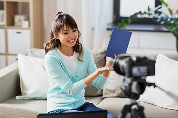 Image showing asian female blogger making video review of book