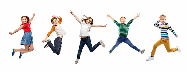 Image showing happy children jumping over white background