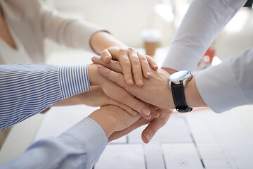 Image showing close up of business team stacking hands