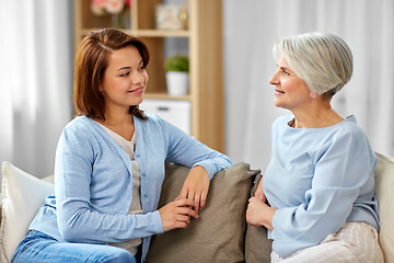 Image showing senior mother talking to adult daughter at home