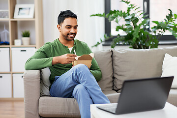 Image showing indian man with laptop eating takeout food at home