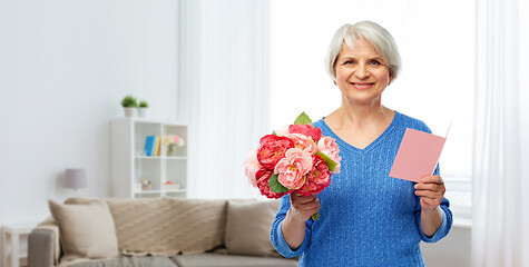 Image showing happy senior woman with flowers and greeting card