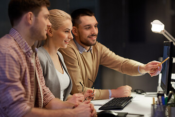 Image showing business team with computer working late at office