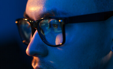 Image showing close up of hacker in glasses looking at screen