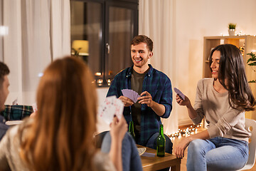 Image showing friends playing cards and drinking beer at home