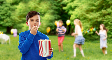 Image showing boy eating popcorn at birthday party