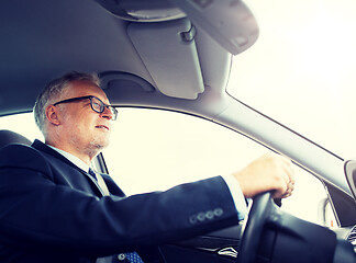 Image showing happy senior businessman driving car