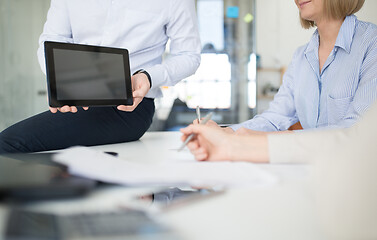 Image showing close up of business team with tablet pc at office