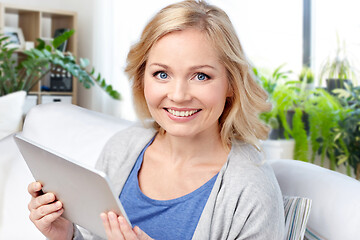 Image showing middle aged woman with tablet computer at home