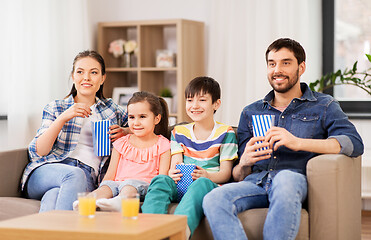 Image showing happy family with popcorn watching tv at home