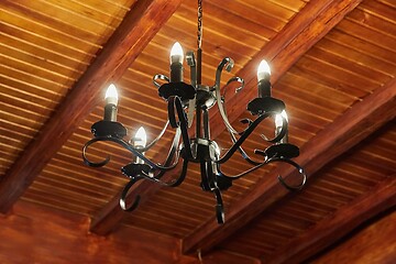 Image showing Chandelier in a wooden house