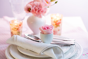 Image showing Place setting with beautiful bouquet in pink and white on the kitchen table