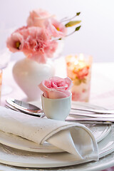 Image showing Place setting with beautiful bouquet in pink and white on the kitchen table