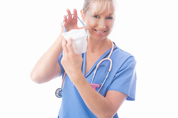 Image showing Nurse putting on a respirator P2 N95 respirator mask