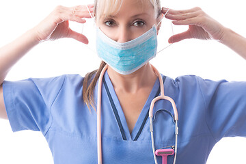 Image showing Nurse or doctor putting on PPE a medical face mask