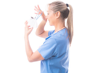 Image showing Nurse or healthcare worker putting on a N95 mask