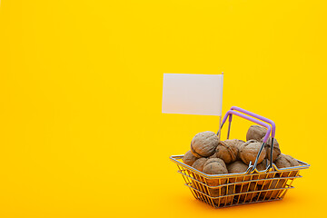 Image showing Walnuts are in the grocery basket, a flag with a white price tag is stuck