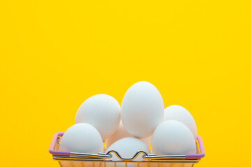 Image showing Chicken eggs are in the grocery basket, bright orange background