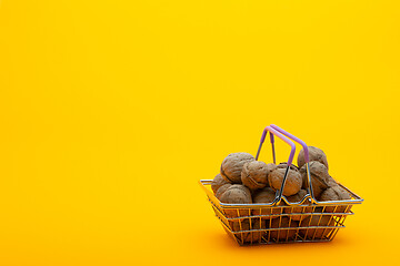 Image showing Walnuts are in the grocery basket, bright orange background