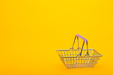 Image showing Empty grocery basket on a bright orange background