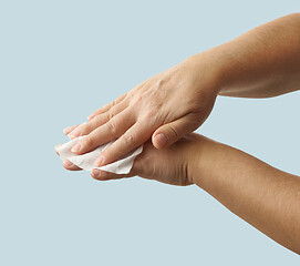 Image showing hands are cleaned with a disinfectant wipe