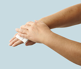 Image showing hands are cleaned with a disinfectant wipe