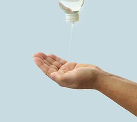 Image showing liquid soap flows on the hand