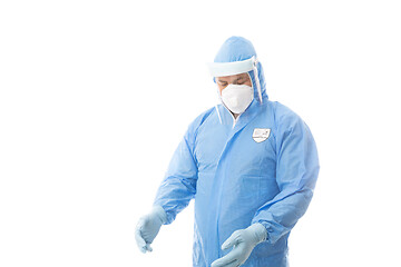 Image showing Worker wearing a hasmat coverall, maskgloves  and face shield