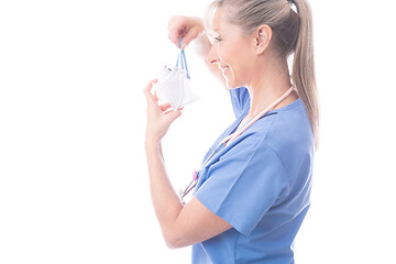 Image showing Doctor of nurse putting on a surgical mask
