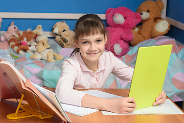 Image showing Girl studying at school online at home.
