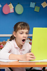 Image showing Girl yawns and watches video tutorials on a tablet