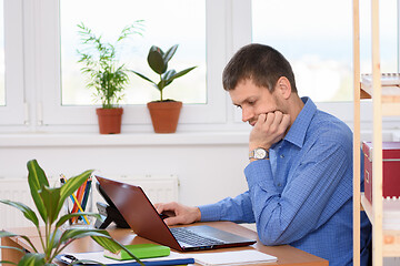 Image showing Office specialist working in a laptop at his workplace