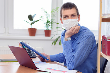 Image showing Office specialist in a medical mask at work