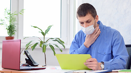 Image showing Ill employee in the office holds his throat