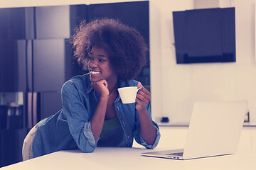 Image showing smiling black woman in modern kitchen