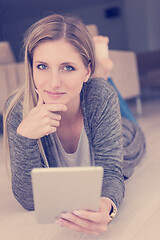 Image showing young women used tablet computer on the floor