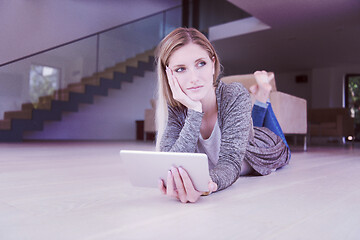 Image showing young women used tablet computer on the floor