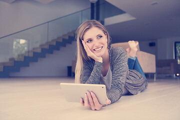 Image showing young women used tablet computer on the floor