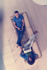 Image showing young multiethnic couple relaxes in the living room top view