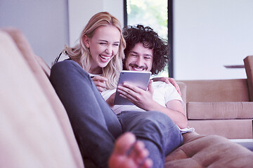 Image showing couple relaxing at  home with tablet computers