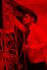 Image showing young it engeneer in datacenter server room