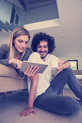 Image showing couple relaxing at  home with tablet computers