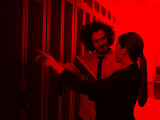 Image showing engineer showing working data center server room to female chief