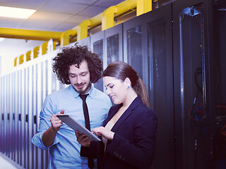 Image showing engineer showing working data center server room to female chief